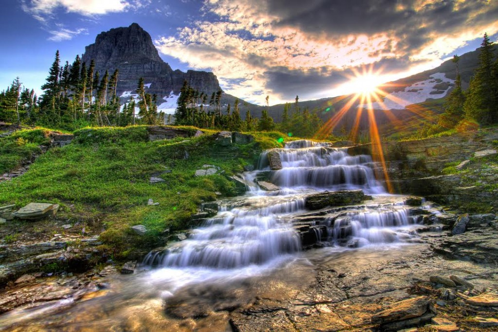 Mountain and waterfall at Logan Pass at sunset in Glacier National Park Montana.