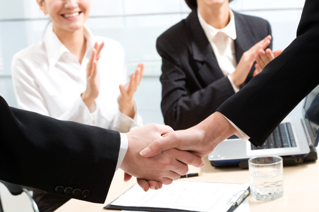 Image of business handshake after signing contract